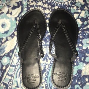 Black braided flip flops